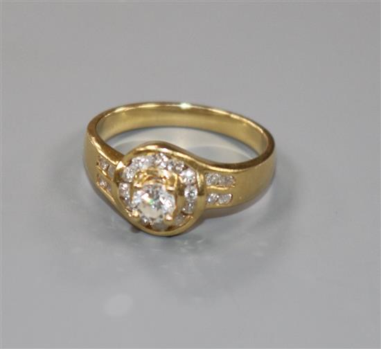 A modern 18ct gold and single stone diamond ring with diamond set setting and shoulders, size M